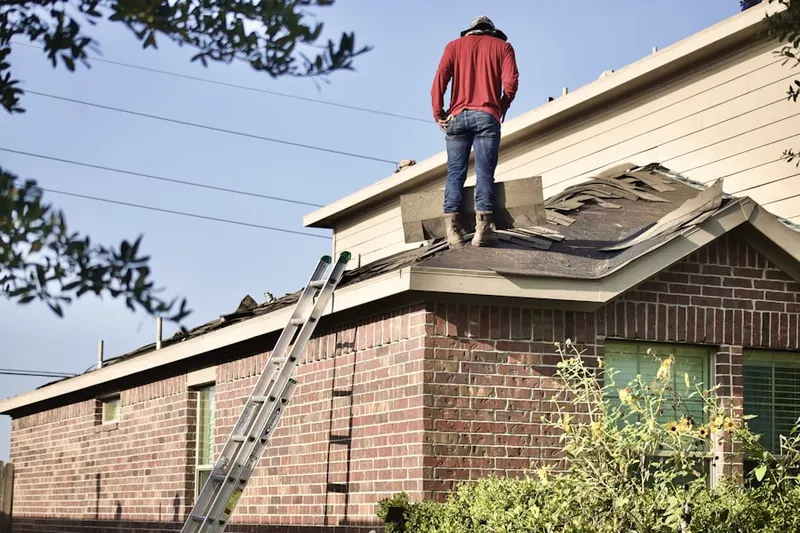 Professional roofer working on a residential roof in Parkway